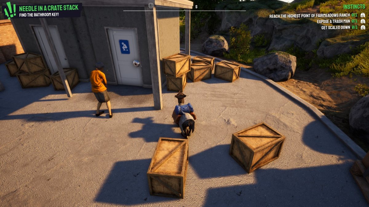Goat standing outside a public toilet with wooden crates lying around.